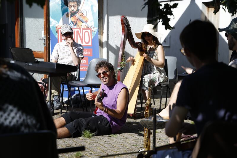 Carlos Otero (Spain - at centre) and Natsuki Silverbirch (Japan, on harp) participate in an Ethno Ireland workshop at Lough Dan Scout Centre. Photograph: Nick Bradshaw/The Irish Times