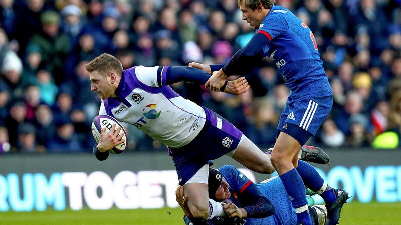 Scotland’s Finn Russell is tackled by Arthur Iturria and Baptiste Serin of France. Photo: James Crombie/Inpho