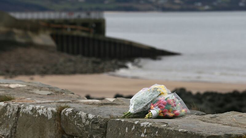 Flowers left at the scene at Buncrana Pier in Co Donegal after five people were killed  after a car they were in slipped from the pier. Photograph: Niall Carson/PA Wire
