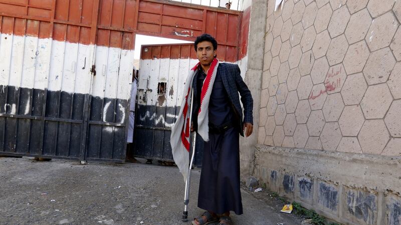 A conflict-wounded Yemeni student leaves his school to have a breakfast during a break in Sana’a, Yemen. Photograph: Yahya Arhab/EPA