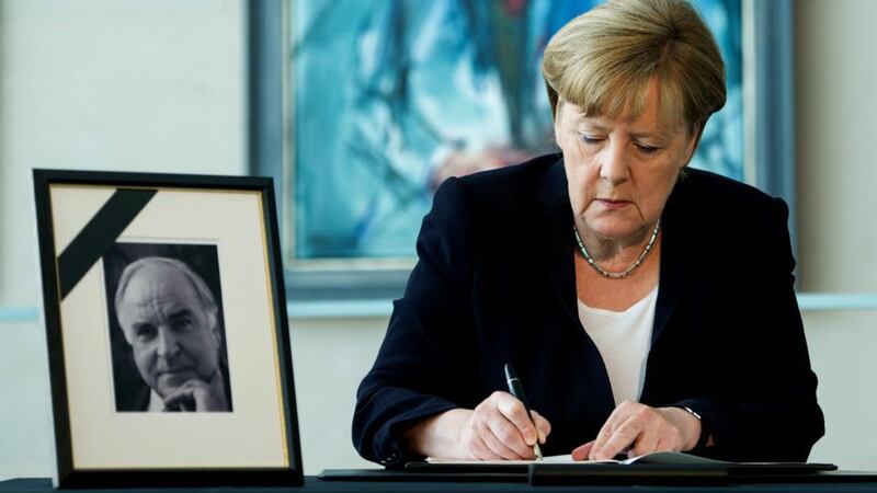 Former protegee: Angela Merkel, the German chancellor, signs a book of condolences for Helmut Kohl. Photograph: Steffi Loos/Getty