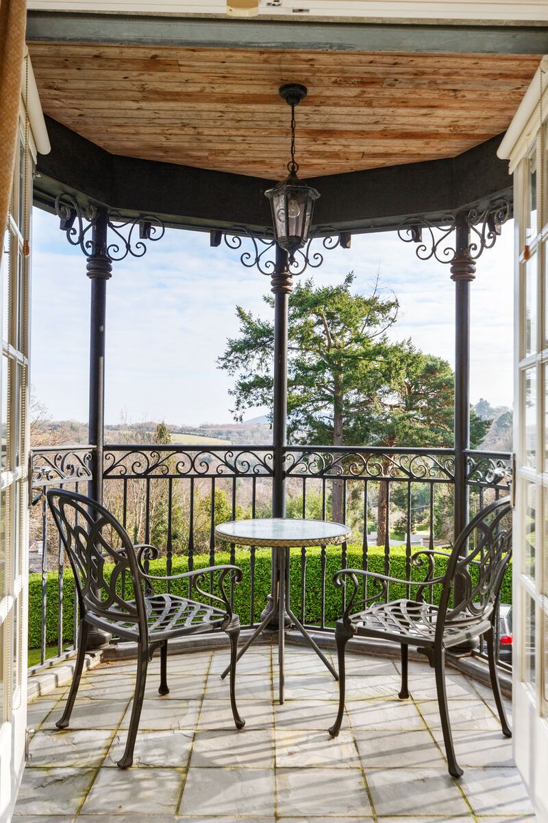 The main bedroom has a neat turreted balcony with distant sea views