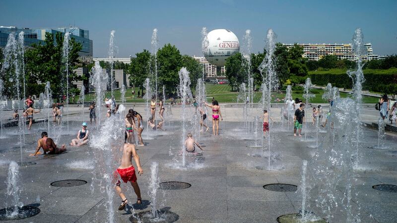 Children cool down at the fountains of Parc Andre Citroen, during the heatwave in Paris.  Photograph: Yoan Valat/EPA