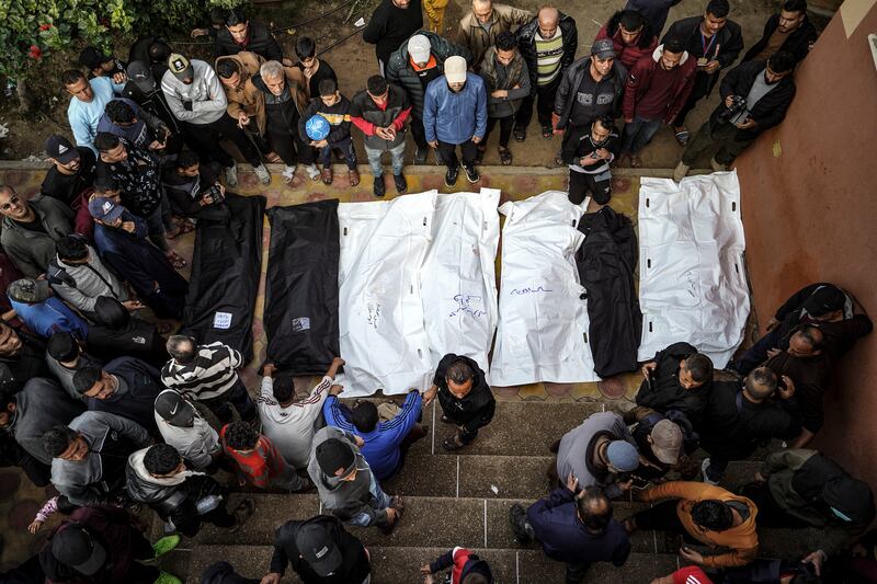 People stand over the shrouded bodies of loved ones killed during Israeli bombardment at Nasser Hospital in Khan Yunis on the southern Gaza Strip on December 27th. Photograph: AFP via Getty Images