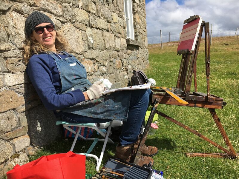 Una Sealy working at the schoolhouse on Barbara Warren's old field easel, on Inishlacken. Photograph: Nancy Keefe Rhodes