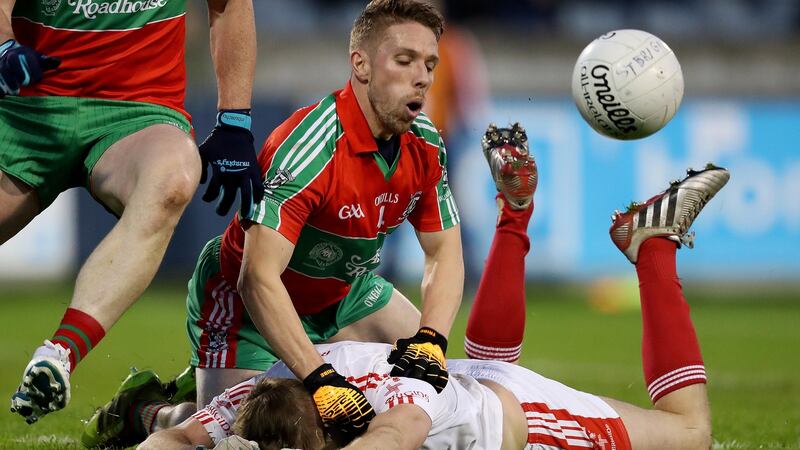 Alan Hubbard of Ballymun and St Brigid’s Philip Ryan. Photograph: Tommy Dickson/Inpho