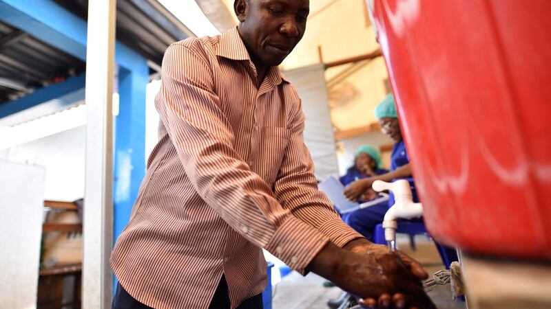 A man washes his hands after ebola screening upon entering the General Hospital in Goma, DRC. Photograph: Olivia Acland/Reuters