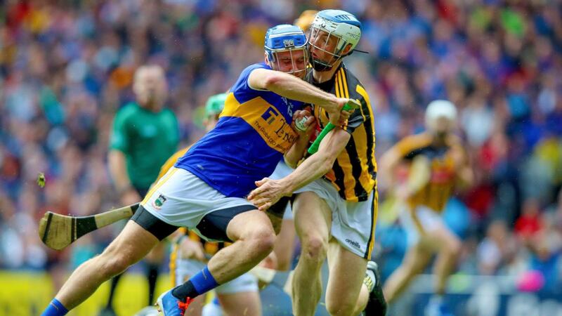 Tipperary’s John McGrath is challenged  by  Kilkenny’s Huw Lawlor during the All-Ireland hurling final at Croke Park. Photograph: Tommy Dickson/Inpho