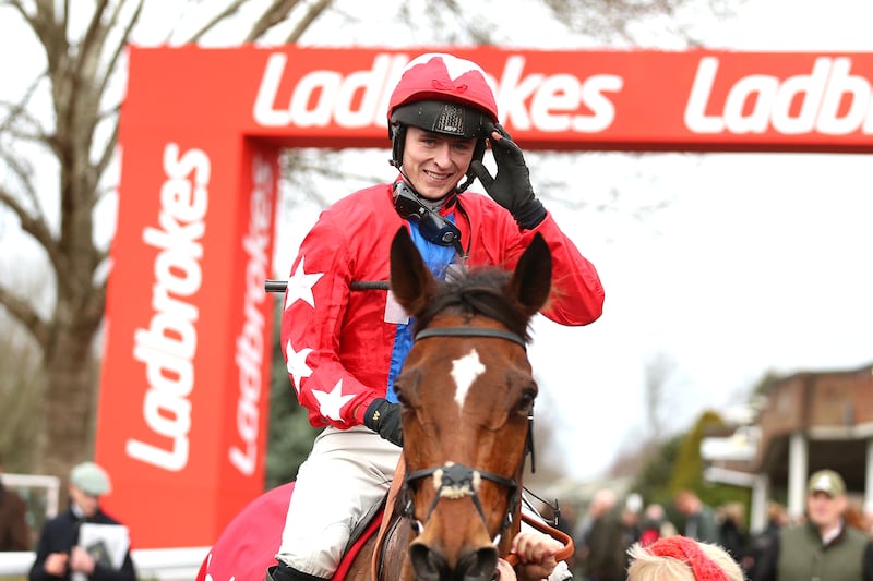 Jockey Niall Houlihan celebrates winning the Ladbrokes Desert Orchid Chase with horse Editeur Du Gite. Photograph: Nigel French/PA Wire.
