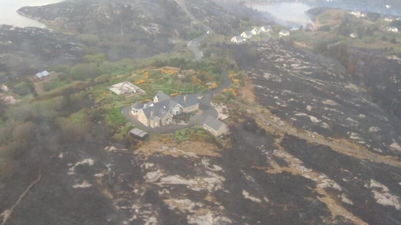 A house is surrounded by scorched earth. Photograph: Air Corps/Facebook