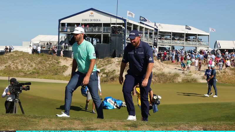 Dustin Johnson and Shane Lowry walk off the 10th green. Photo: Stacy Revere/Getty Images