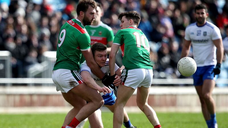 Monaghan’s Conor McCarthy is tackled by Aidan O’Shea and Fergal Boland of Mayo. Photograph: Bryan Keane/INPHO