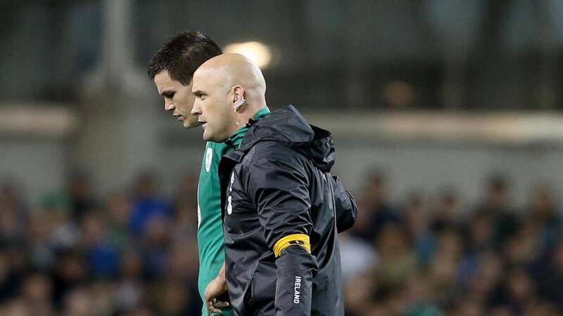 Ireland outhalf Jonathan Sexton is led from the field during the Australia game by  Dr Éanna Falvey. Photo: Dan Sheridan/Inpho