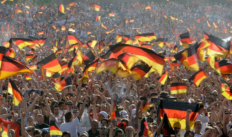 Thousands of football fans with German national flags celebrate the start of the World Cup 2006 at a public viewing zone in Hamburg. Photograph: Friedemann Vogel/Getty Images