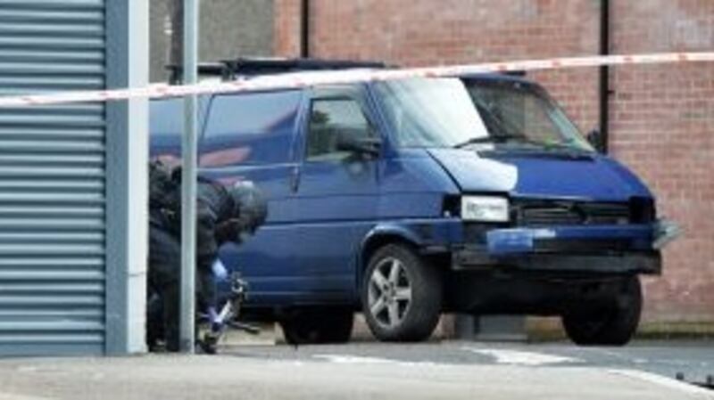 A bomb disposal unit officer inspects the van of a prison officer under which a bomb partially detonated at Hillsborough Drive on March 4th. Photograph: Getty Images
