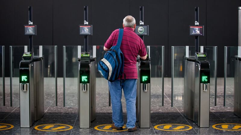 A passenger scans his boarding card in Terminal 2 at Heathrow Airport in London. The British Government has banned certain electronic devices on flights from certain Middle East countries following a similar move by the US authorities. Photograph: Andrew Cowie/EPA.
