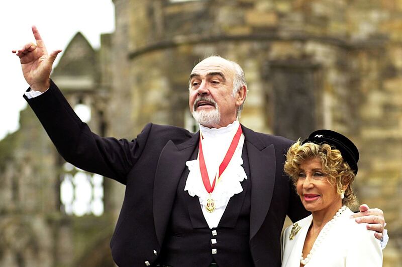 Sean Connery, with his wife Micheline Roquebrune, wearing his medal after being knighted by Queen Elizabeth in Edinburgh. File photograph: PA