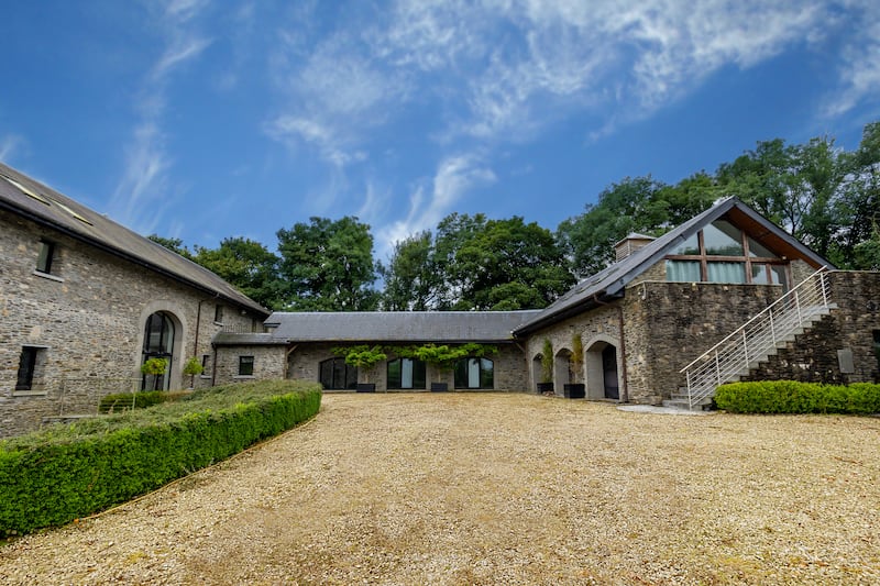 Grounds with main house on the left and converted garage on the right. Photograph: James Osborne
