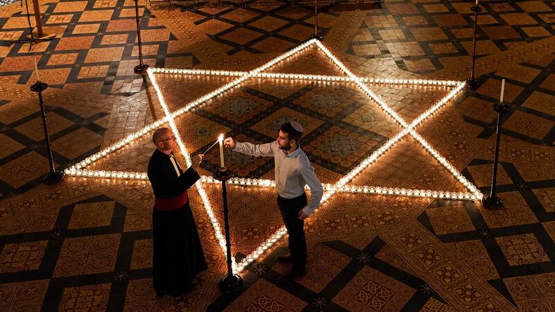 The Reverend Canon Dr Christopher Collingwood, Canon Chancellor of York Minster and Joshua Daniels from University of York Jewish Society light some of the 600 candles shaped as a Star of David on the floor of the Chapter House of York Minster as part of a commemoration for Holocaust Memorial Day last Thursday. Photograph: Ian Forsyth/Getty Images