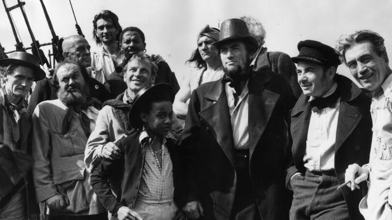 The cast and crew of the Warner Brothers film Moby Dick on location in Youghal, County Cork. Members include Richard Basehart, Gregory Peck (1916 - 2003) as Captain Ahab, Leo Genn (1905 - 1978) in the sailor’s cap, and director John Huston (1906 - 1987) on the far right. Photograph: Fox Photos/Getty Image