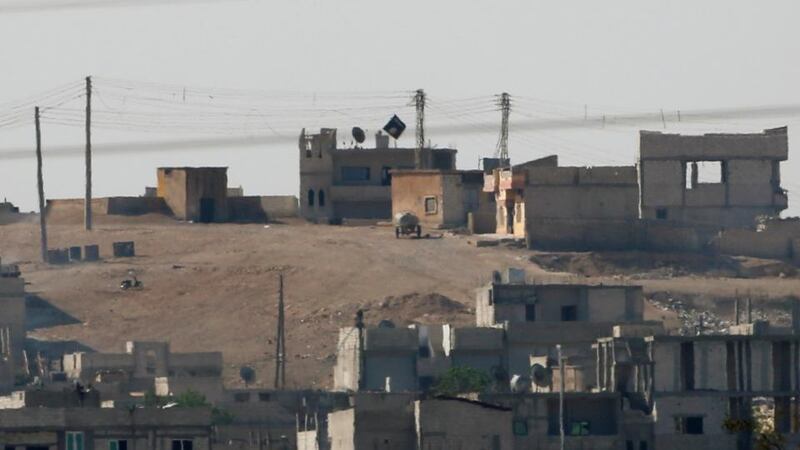 A black flag belonging to the Islamic State is seen in the Syrian town of Kobani, as pictured from the Turkish-Syrian border near the southeastern town of Suruc. Photograph: Umit Bektas/Reuters