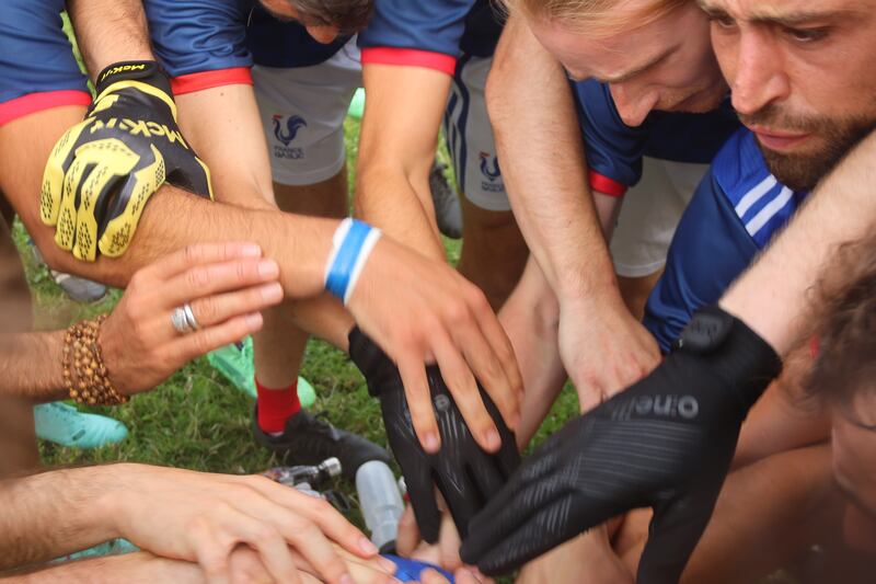Hands in: France team together before their match against Portobello in Rathmines.