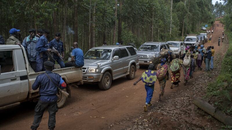 The police escort a convoy of health workers to the remote village of Luseghe, where a woman had died of Ebola, in the Democratic Republic of Congo. Photograph: Diana Zeyneb Alhindawi/The New York Times