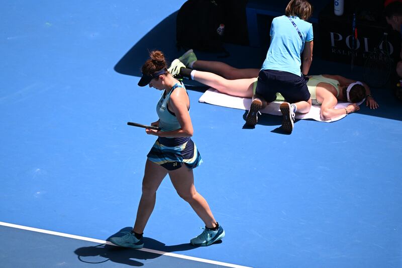 Czech Republic's Linda Noskova walks past Ukraine's Elina Svitolina receiving treatment during their women's singles match in Melbourne. Photograph: William West/AFP via Getty Images