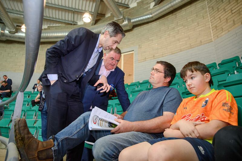 Taoiseach Simon Harris and Fine Gael’s Ireland South European candidate John Mullins with farmer Tom Sheehy and son Donnacha from Ballygarvan at Corrin Mart, Co Cork. Photograph: Daragh McSweeney/Provision