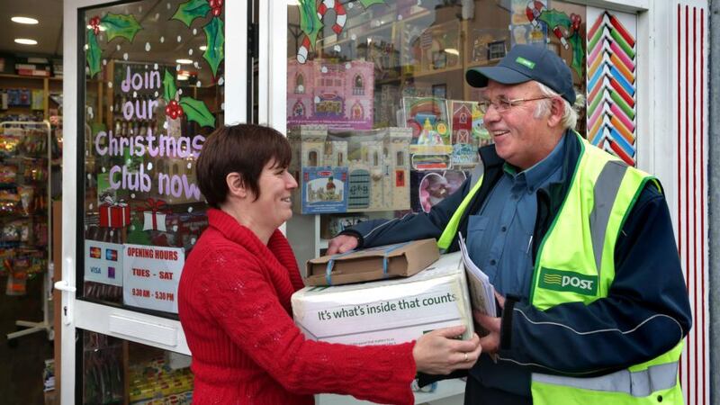 Damien Tuohy delivering Christmas post to Majella Piggott at the Gort Educational World shop in the Co Galway town. Photograph:  Joe O’Shaughnessy