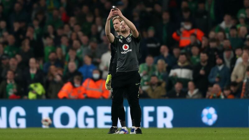 A pitch invader takes a selfie with Ireland goalkeeper Caoimhín Kelleher during the friendly international against Lithuania at the Aviva Stadium. Photograph:  Oisín Keniry/Getty Images
