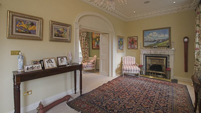Reception rooms at the front of the house flow into one another: the front porch opens into a reception hall which opens through an arch into the drawingroom.
