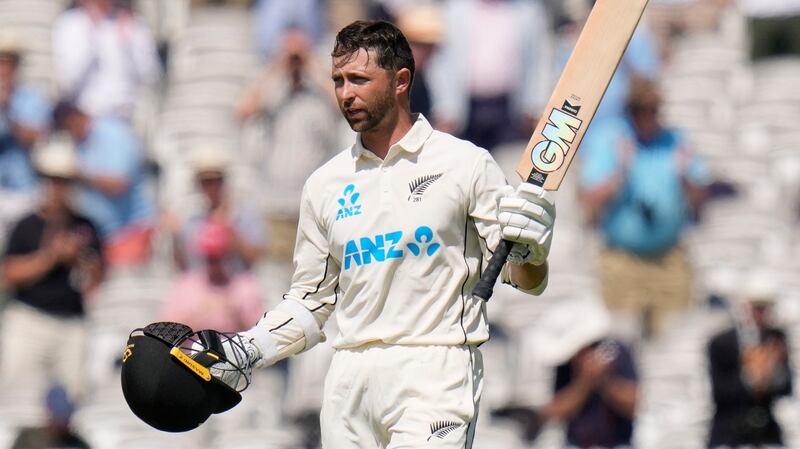 New Zealand’s Devon Conway raises his bat after completing his double hundred on Thursday. Photograph:  Kirsty Wigglesworth/AP