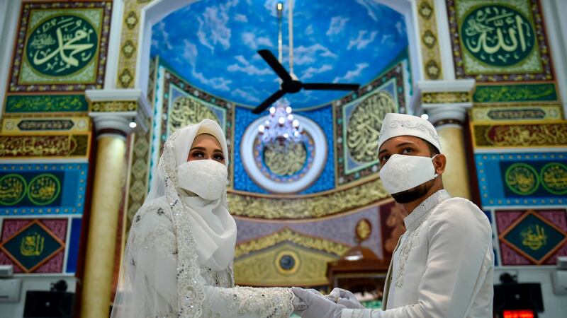 A couple wearing face masks  attends  their wedding ceremony at a mosque in Banda Aceh, Indonesia on Wednesday. Photograph: Chaideer Mahyuddin/AFP/Getty Images
