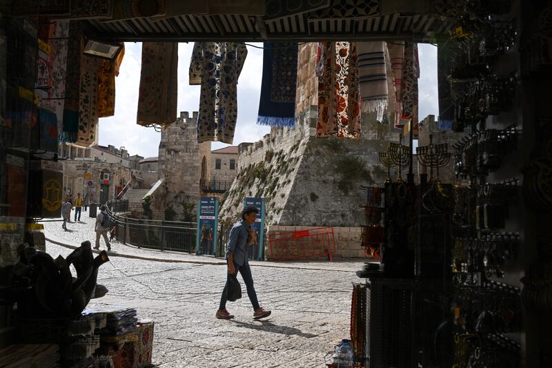 A youth walks past empty tourist shops in Jerusalem's Old City on Wednesday, as the war between Israel and Hamas in the south of the country entered its fifth day. Photograph: Yuro Cortez/AFP via Getty Images