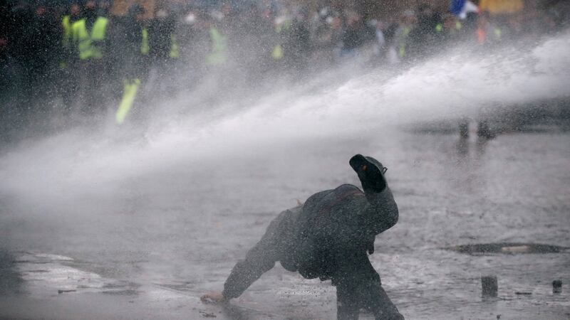 Police use a water cannon during a demonstration by the yellow vests movement near the Arc de Triomphe in Paris. Photograph: Reuters