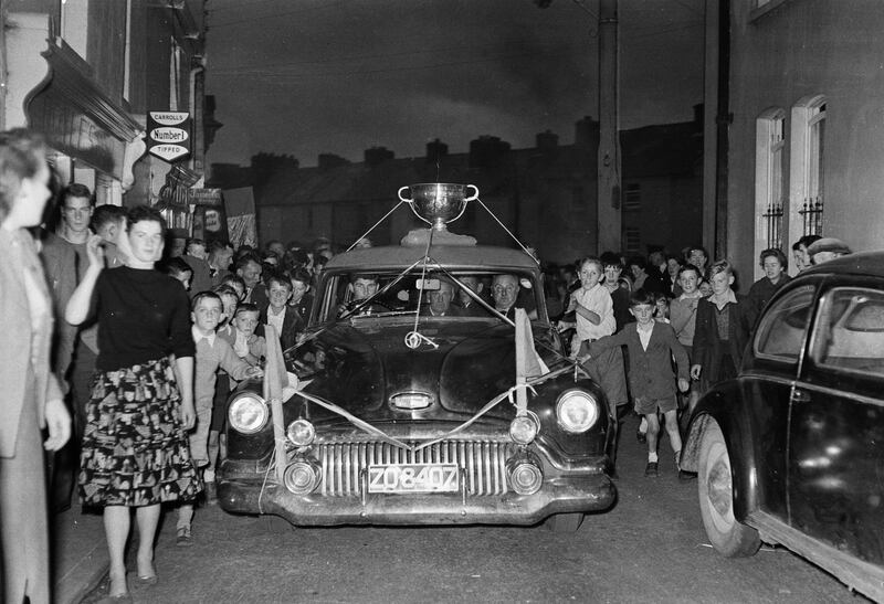 October 1959; Crowds line the way as Mick O'Dwyer drives members of the Kerry team and the Sam Maguire Cup to Valentia. The Kingdom defeated Galway 3-7 to 1-4 to win the All-Ireland Senior Football Championship. Photograph: Padraig & Joan Kennelly/Kennelly Archive