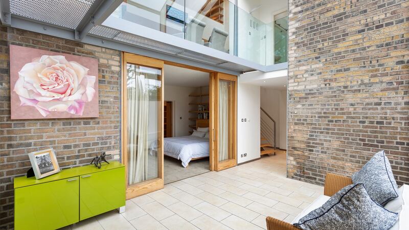 Glazed doors linking master bedroom with conservatory.