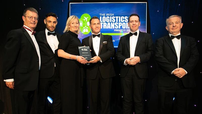 Garrett McClean, Executive Director, CBRE presents the Employer of the Year award to the DHL Global Forwarding Ireland team.