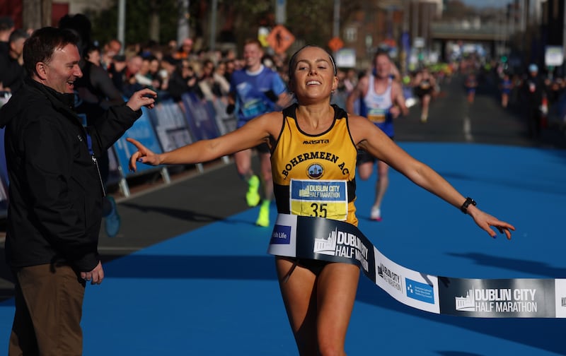 Nichola Sheridan crosses the line to win the women's race. Photograph: Stephen Collins/Collins Photos