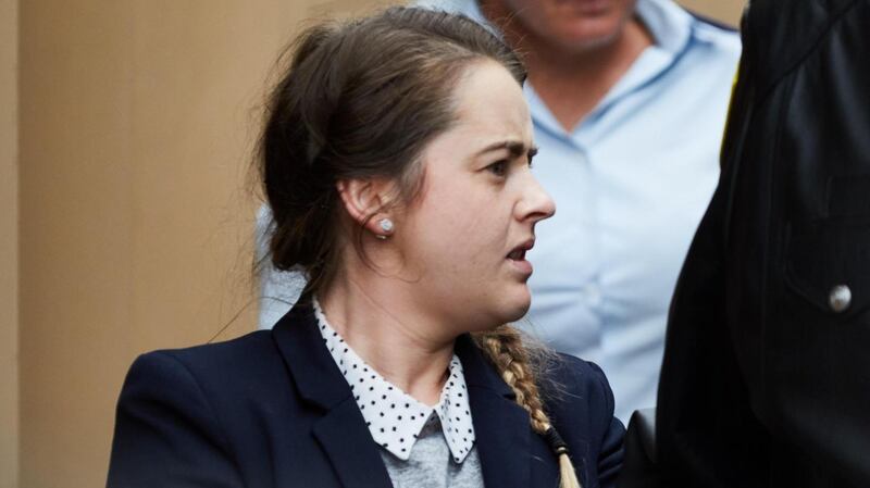 Cathrina Cahill (27) is escorted after her sentencing in the Supreme Court in Sydney, Australia. Photograph: EPA/ERIK ANDERSON