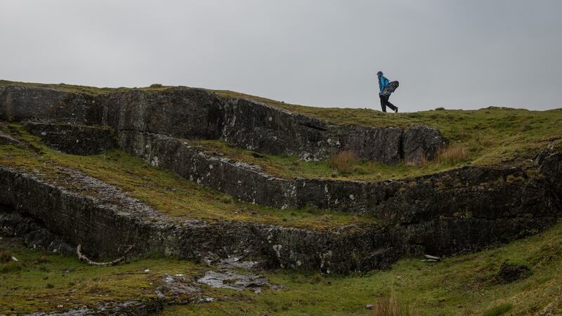 A player walks above an old quarry while looking for the ball from his first drive at a golf course just outside Rhayader, Wales. Photograph: Phil Hatcher-Moore/The New York Times