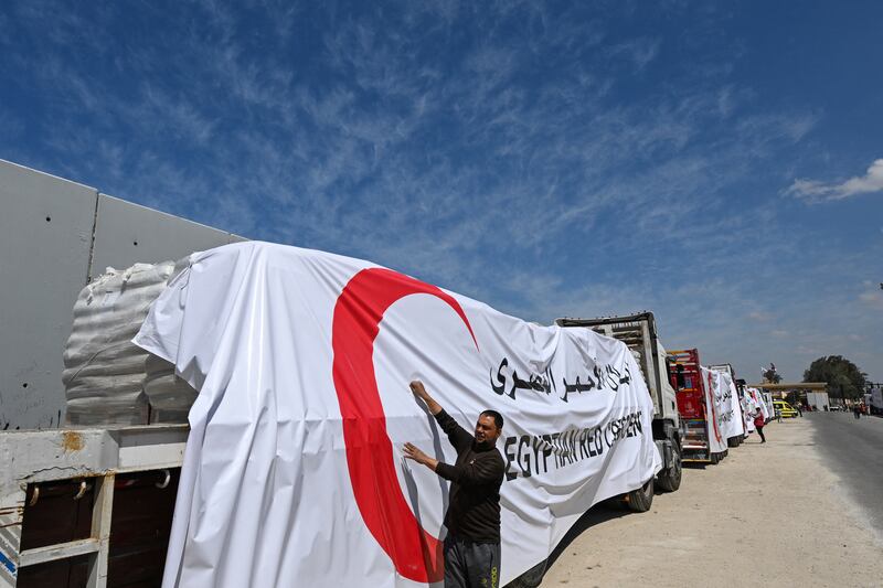 Egyptian Red Crescent trucks loaded with aid queue outside the Rafah border crossing with the Gaza Strip. Photograph: Khaled Desouki/AFP/Getty