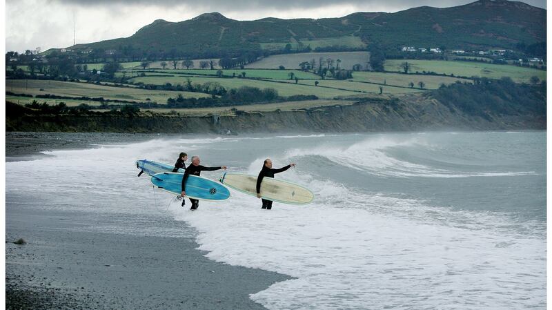 East Coast Surfing Club members Fergus Halpin (left), Tim Ferguson (right), with Kevin Cavey (centre) take to the water at Greystones in 2008. Photograph: Alan Betson.