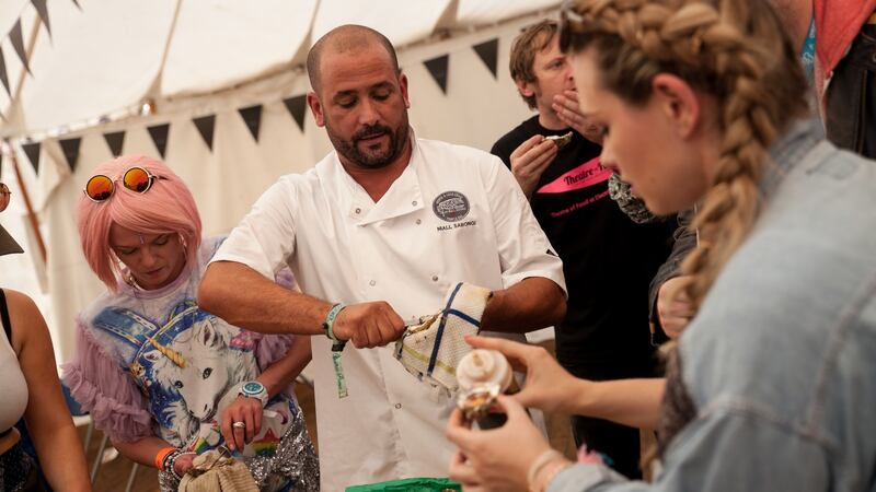 Niall Sabongi showing festival goers how to shuck an oyster. Photograph: Ruth Medjber