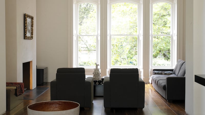 John Rocha’s sitting room: “I like to create calm, relaxing environments so I use a tight neutral palette of materials to create space, broken white walls and ceilings, dark wooden or light stone or marble floors.” Photograph:  Simon Brown