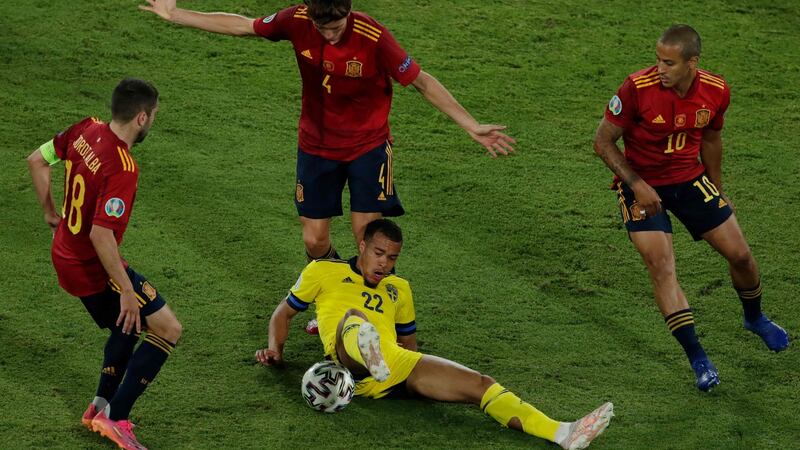 Sweden midfielder Robin Quaison  is surrounded by Spain’s Jordi Alba, Pau Torres and Thiago Alcantara during the Euro 2020 Group E match at La Cartuja Stadium in Seville. Photograph:  Julio Munoz/AFP via Getty Images