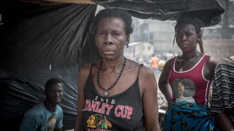 Isatu Kabia stands with her family on the site where her home used to be, in Susan’s Bay, Freetown. Photograph: Sally Hayden