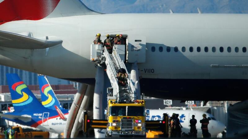 Firefighters enter a British Airways plane that caught fire at McCarren International Airport  in Las Vegas on Tuesday. Photograph: John Locher via AP.
