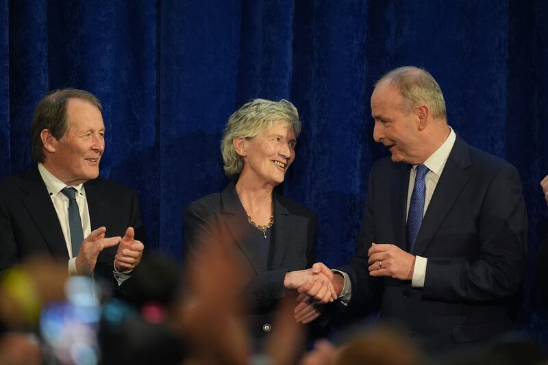 Catherine Connolly is congratulated by her husband, Brian McEnery, and Taoiseach Micheál Martin at Dublin Caste. Photograph: Niall Carson/PA Wire 